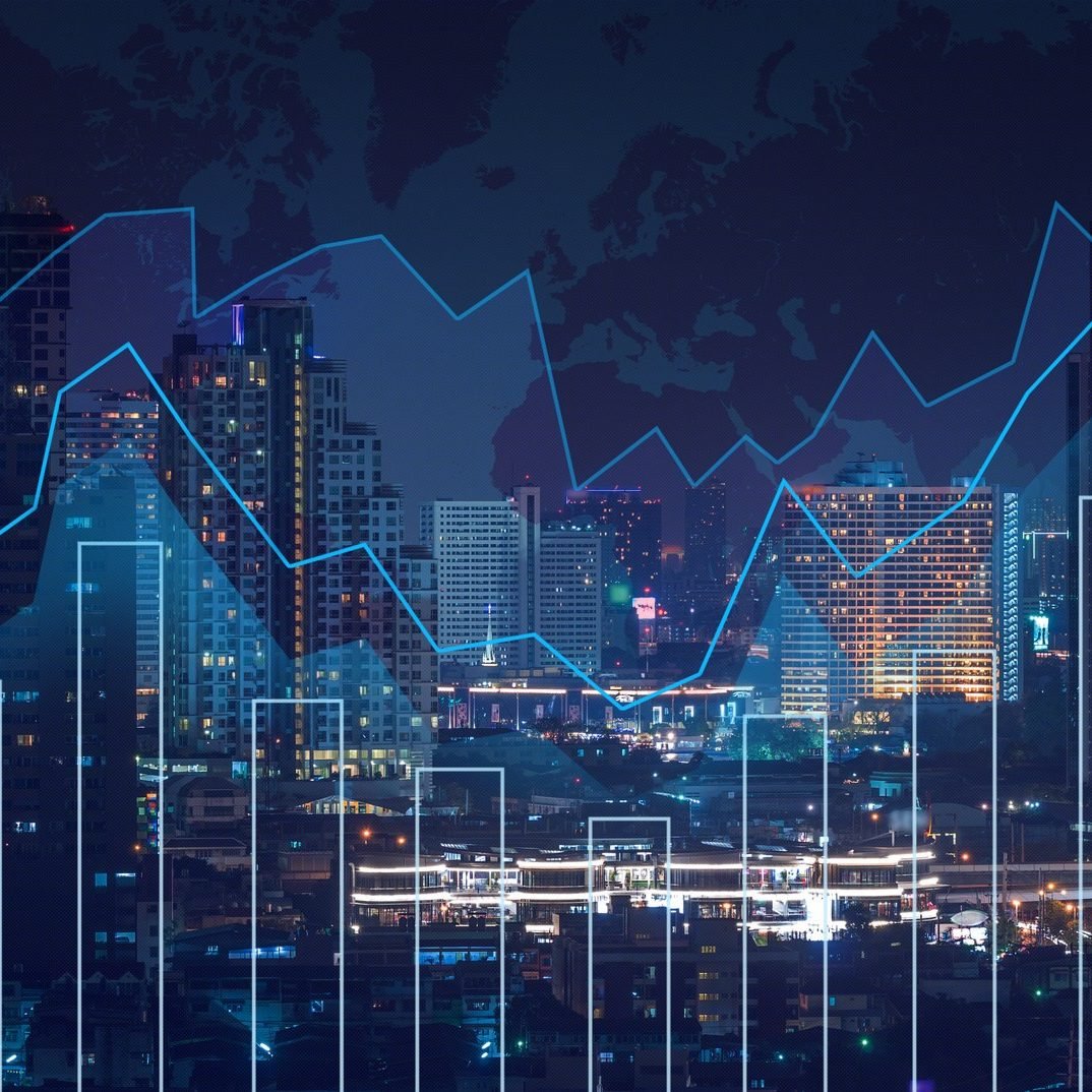 Trading graph on the cityscape at night and world map background,Business financial concept